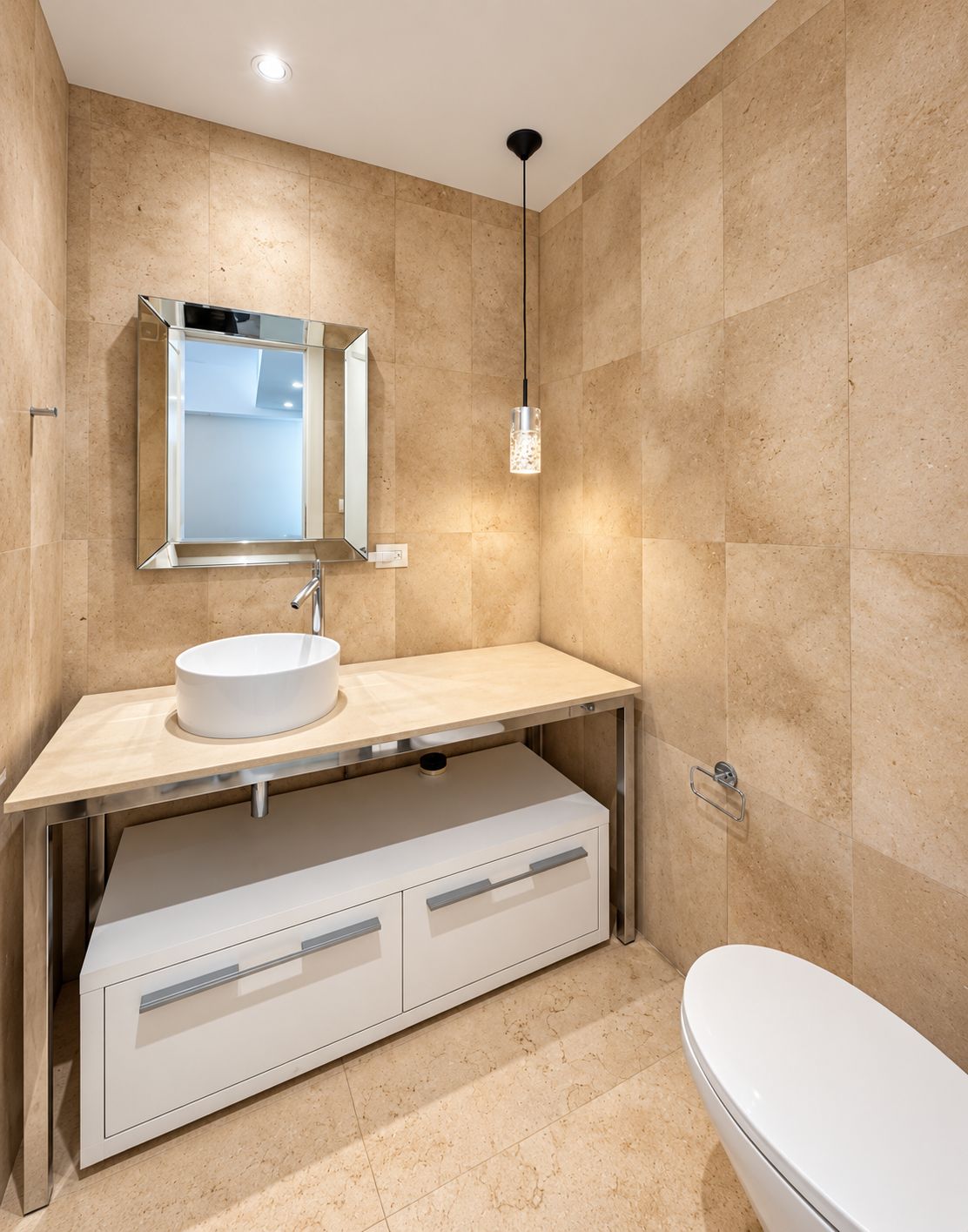 A modern bathroom with a white sink, mirror, and a toilet.