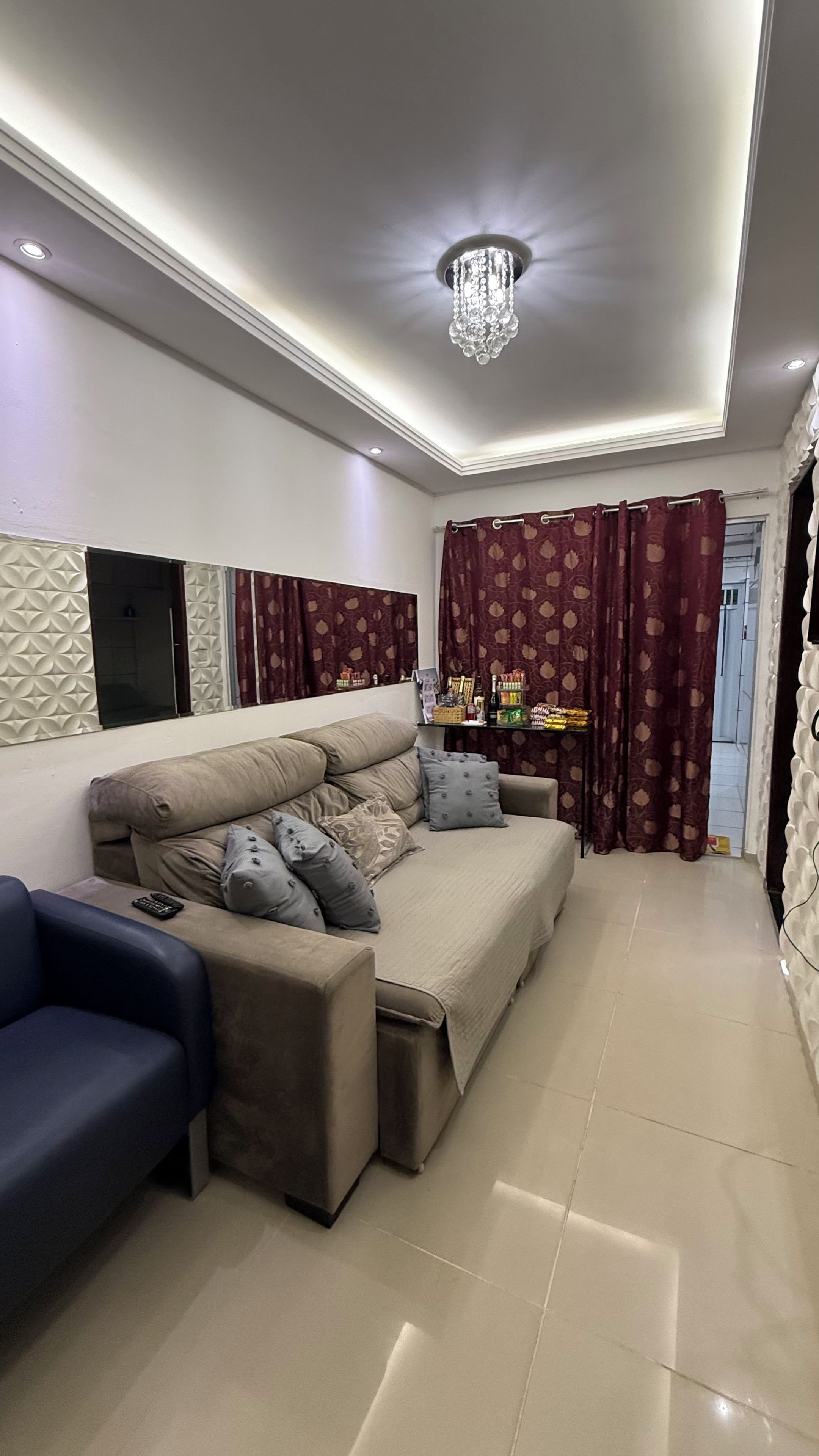 A modern living room with a sofa, a coffee table, and a TV.
