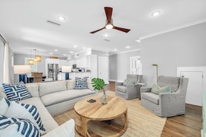 A modern living room with a sofa, armchair, coffee table, and a ceiling fan. - Mojito House with Private Pool, Gulf Views, Walk to Beach, Dune Allen (Santa Rosa Beach)