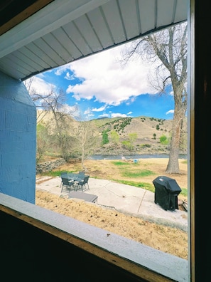 A patio with outdoor furniture, a barbecue grill, and a view of a river and hills. - Cozy / River Front / Charm (Salida)