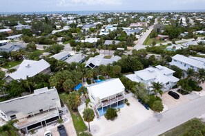 A residential area with houses, palm trees, and a clear sky. - Offering 5% Rebate on Room Rate if Booked by 9pm (Holmes Beach)