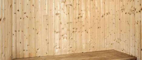 A wooden bench against a wooden wall.