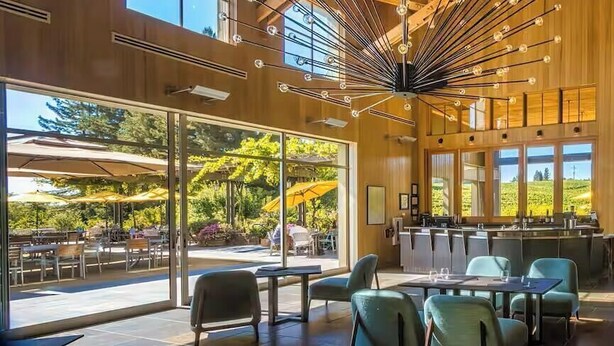 An indoor dining area with tables and chairs, large windows, and a view of the outdoors. - Luxury Forestville Ranch: Pool+Hot Tub+Fire Pit (Forestville)