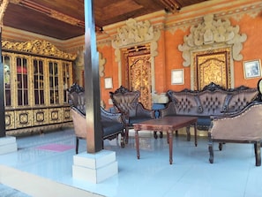 A room with ornate furniture, a large cabinet, and a decorative ceiling.