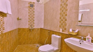 A bathroom with a toilet, sink, and shower. - Corporate Stays (Chengalpattu)