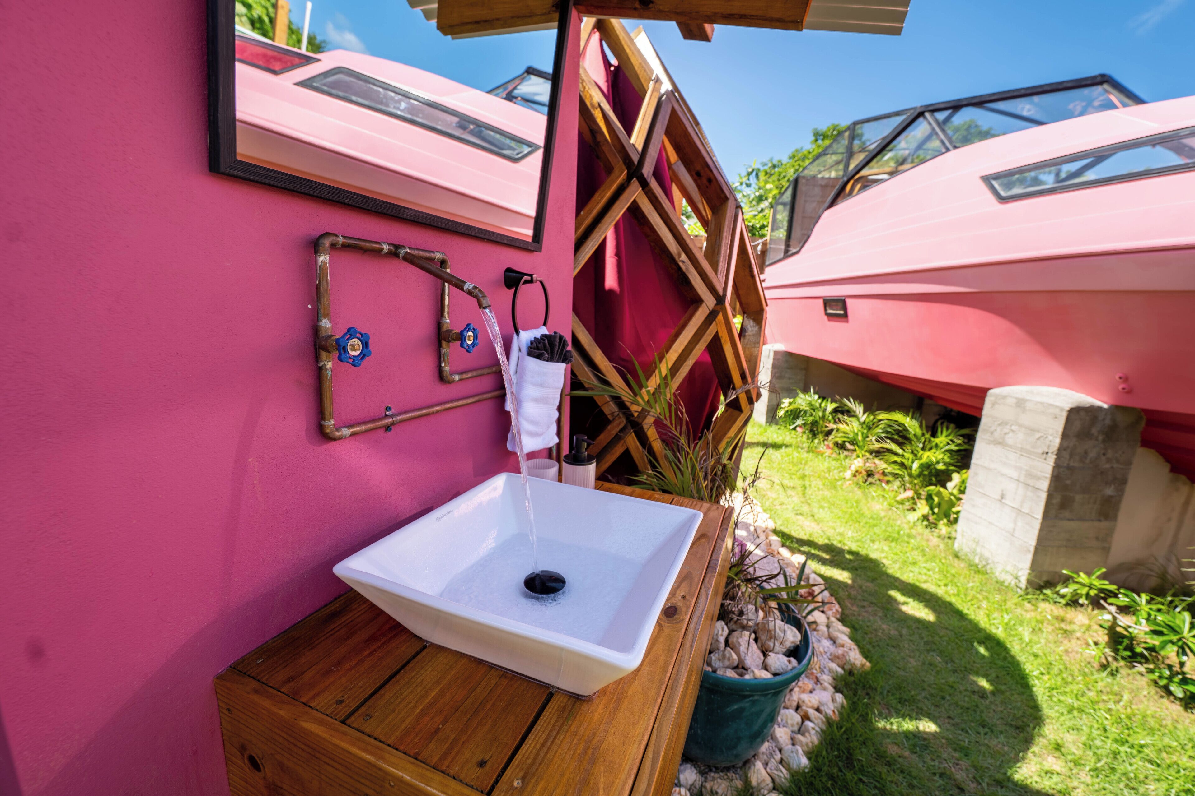 A bathroom with a wooden cabinet, a white sink, and a mirror.