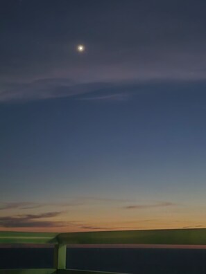 A night sky with a visible moon and a horizon line. - Spacious 4-bedroom house with AC in amazing Brevard CONNESTEE FALLS (Brevard)