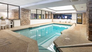 An indoor swimming pool with stone walls and a clear view of the adjacent room. - Ski Retreat Condo w/ Pool, Hot Tub & Balconies (Winter Park)
