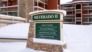 A sign for 'SILVERADO II' with amenities listed: Event Center, Vacation Rentals, Indoor Pool & Tubs, Hideaway Bistro. - Ski Retreat Condo w/ Pool, Hot Tub & Balconies (Winter Park)