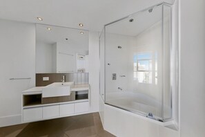 A modern bathroom with a glass shower enclosure, a large mirror, and a white vanity with a towel rack. - The Gilded Gallery I Art-Inspired Luxe (Brisbane City)
