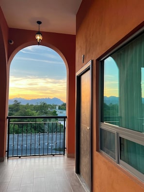 A balcony with a view of mountains and a sunset. - Hotel Las Carolinas (Cadereyta Jiménez)