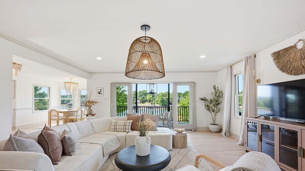 A spacious living room with a sectional sofa, a round coffee table, and a large TV. - Casa del Sol | Pickle ball court| Fire pit | Dock | Sleeps 10 (Mooresville)