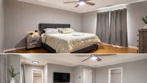 Een slaapkamer met een bed, nachtkastje, dressoir, plafondventilator en een televisie.