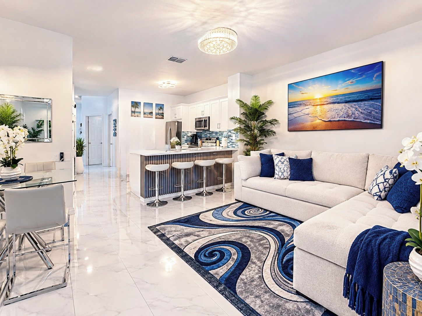 A modern living room with a sofa, a coffee table, and a dining area with chairs.