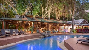 A pool area with lounge chairs and a covered seating area. - [TROPICS] Ramada Resort & Spa 🏝 Free Wifi in Room (Port Douglas)