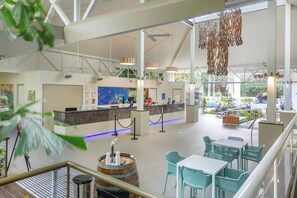 A spacious lobby with a reception desk, seating area, and a large aquarium. - [TROPICS] Ramada Resort & Spa 🏝 Free Wifi in Room (Port Douglas)