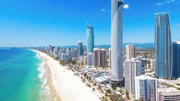 A coastal cityscape with high-rise buildings, a beach, and clear skies. - [OCEAN SIDE] North East Ocean View Twin @ Mantra (Surfers Paradise)