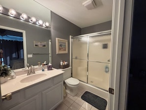 A bathroom with a sink, toilet, and shower. - Waterfront Lake Escape - Pool, Dock, Sunset Views (Osage Beach)