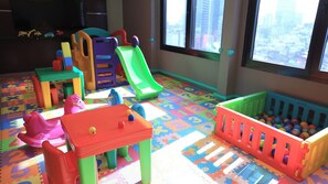 A playroom with colorful toys, a slide, and a ball pit. - City-Centric Room Ideal for Walking to The Obelisk | Rooftop Pool, Pet-Friendly (Buenos Aires)