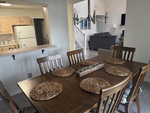 A dining area with a wooden table, woven placemats, and chairs. - Beautiful Townhouse in Lewes Parking Clean Spacious (Lewes)