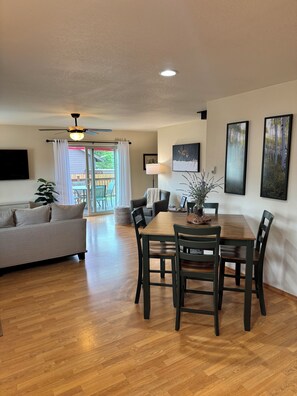 A spacious living area with a dining table, chairs, a sofa, and a ceiling fan. - Hatcher Lake Home With Views & Forest Access (Pagosa Springs)