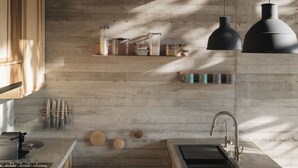 A kitchen with a concrete ceiling, wooden cabinets, a sink, and pendant lights. - Casa Nu La Saladita surf point (Saladita)