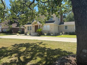 A residential house with a front porch, a driveway, and a well-maintained lawn. - The Marble Manor by Boardwalk (Myrtle Beach)