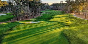 A golf course with well-manicured fairways, sand bunkers, and a water hazard. - The Marble Manor by Boardwalk (Myrtle Beach)