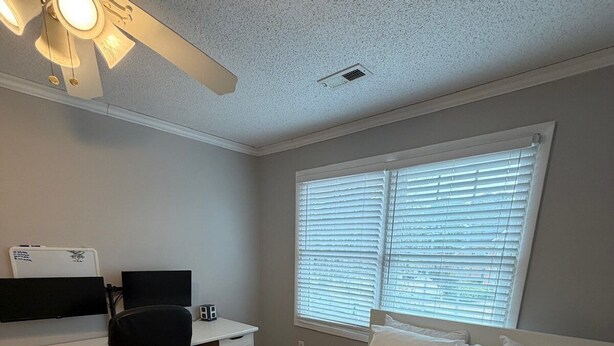 A bedroom with a bed, desk, chair, and ceiling fan. - The Marble Manor | House & Loft (Myrtle Beach)