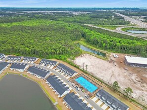 An aerial view of a campground with RV parking, a swimming pool, and a large open area. - Mermaid Soirée near the Beach (Myrtle Beach)