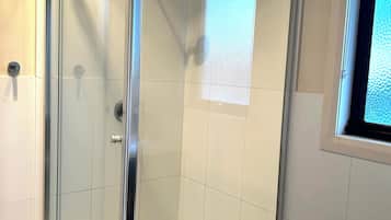 Shower, towels, soap, toilet paper