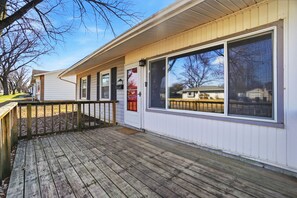 A single-story building with a wooden deck, large windows, and a mailbox. - Beautiful 3-bedroom house (Dayton)