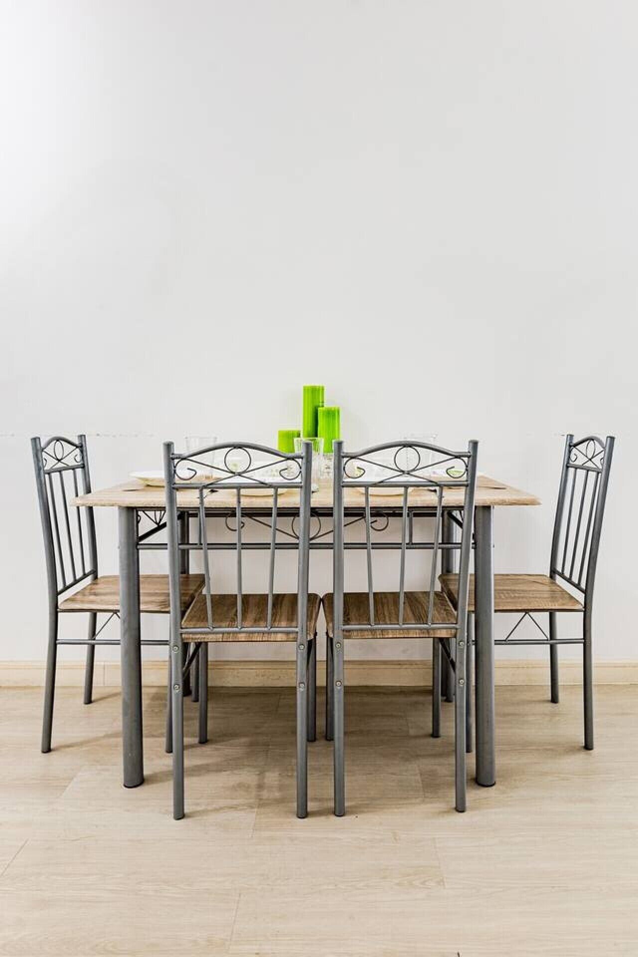 A dining table with four chairs, a wooden top, and metal legs.