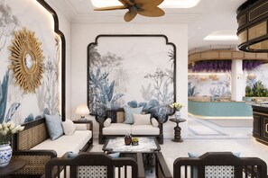 A modern hotel lobby with a sofa set, a coffee table, and a decorative mirror. - M Signature Boutique Hotel & Villas Beachfront Phu Quoc (Phu Quoc)