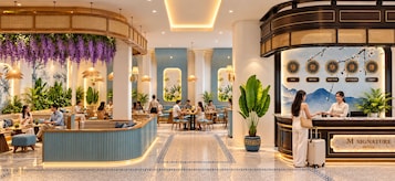 A hotel lobby with seating areas, a reception desk, and a wall with clocks indicating different time zones.