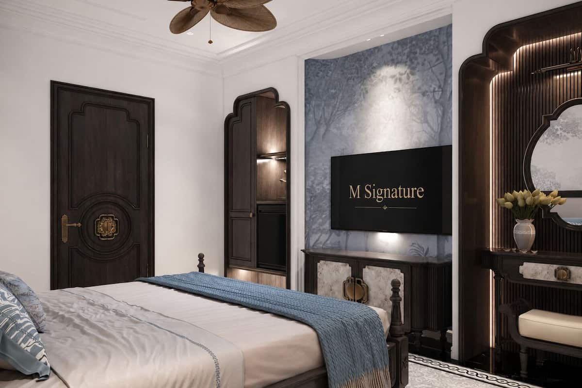 A bedroom with a bed, a television, a fireplace, and a mirror.
