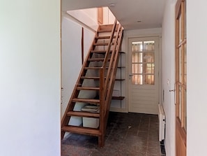 A wooden staircase with a handrail, leading to a door with a window. - Jizera cottage by Interhome (Rokytnice nad Jizerou)
