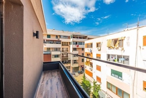 A balcony with a view of multi-story buildings, a clear sky, and a metal railing. - Relax Inn Hotel (Durrës)