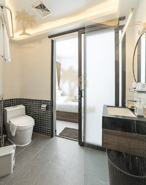 A modern bathroom with a toilet, bidet, and sink. - Terra Calm Mountain View Villa Da Nang (Son Tra)