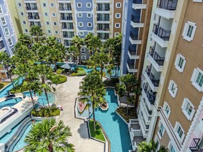 A multi-story hotel with a central swimming pool surrounded by palm trees and balconies. - Seven Seas Cote D'Azur Nice by GV (Tambon Na Chom Thian)