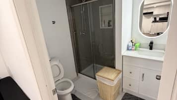 Shower, towels, soap, toilet paper