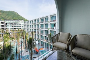 A hotel balcony with a view of a swimming pool and a mountain. - Sugar Marina Hotel Pop, Kata Beach (Karon)