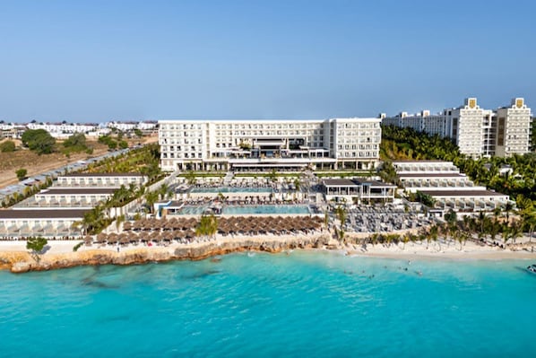 A large hotel with multiple buildings, a pool area, and a beach. - Hotel Riu Palace Swahili - Adults Only - All Inclusive (Nungwi)