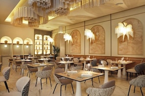 A restaurant with tables set for dining, overhead lighting, and wall art. - Hotel Riu Palace Swahili - Adults Only - All Inclusive (Nungwi)