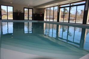 An indoor swimming pool with clear reflections, large windows, and potted plants. - Le Domaine des Mon di res C36v (Meyrignac-l'Eglise)