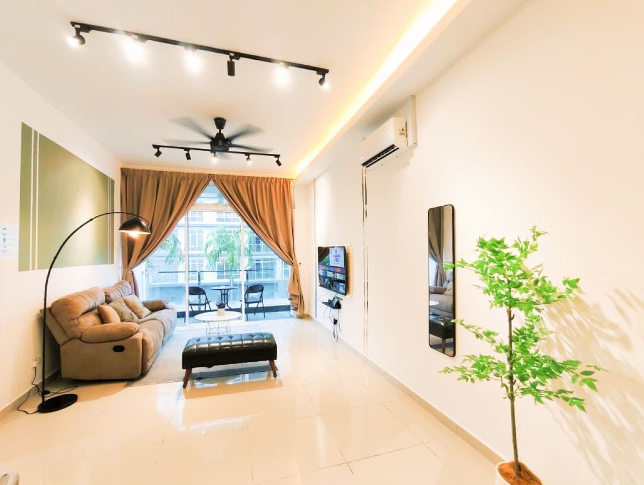 A modern living room with a sofa, a coffee table, a floor lamp, a ceiling fan, and a large window with curtains.