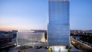 A modern hotel with a glass facade, a prominent entrance, and a cityscape in the background. - PALACE Hotel（Hangzhou Huayin Tower Hangzhou City University） (Hangzhou)
