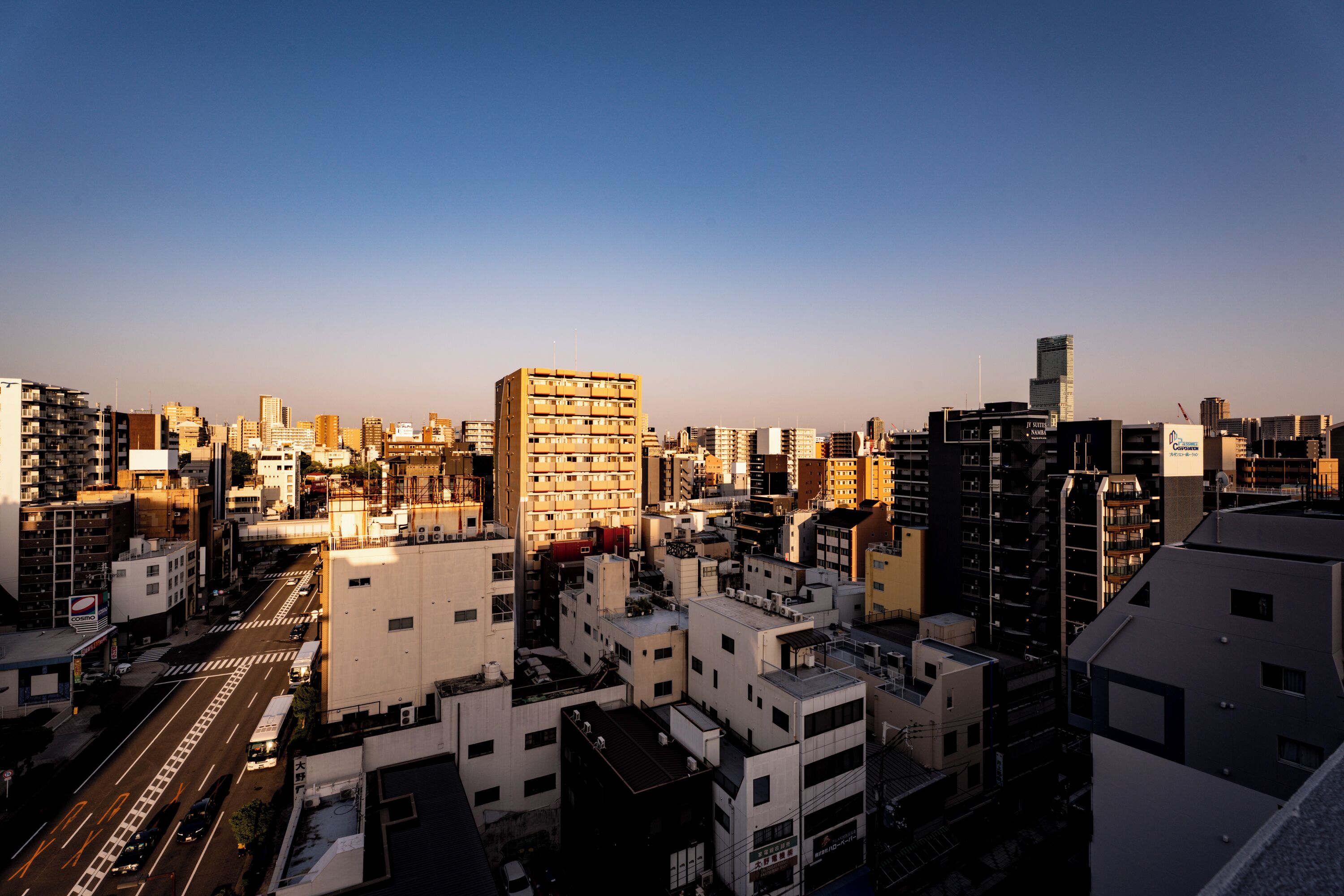 A cityscape with a variety of building types, including high-rise and mid-rise structures, and a clear sky.