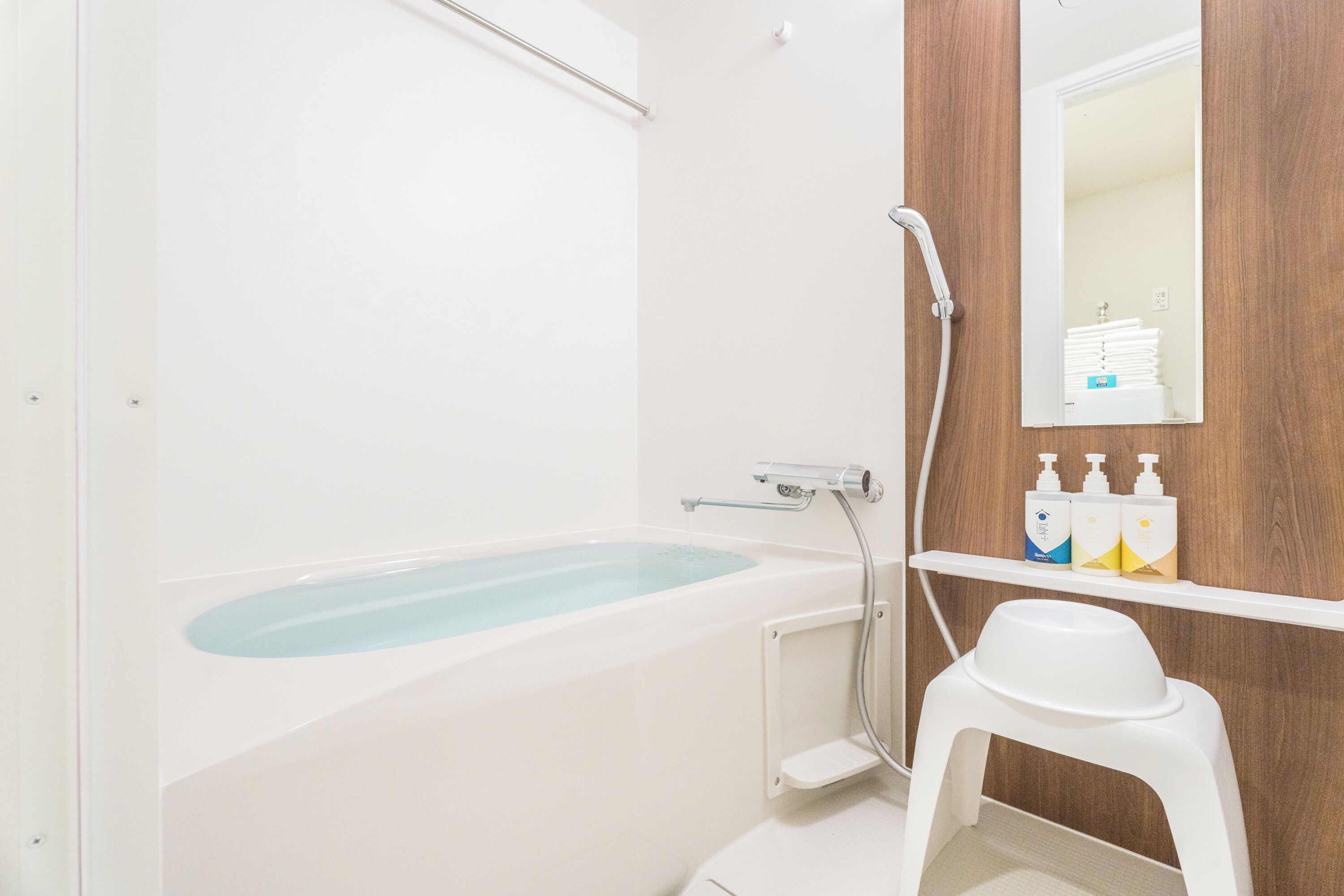 A modern bathroom with a bathtub, a shower, and a toilet.
