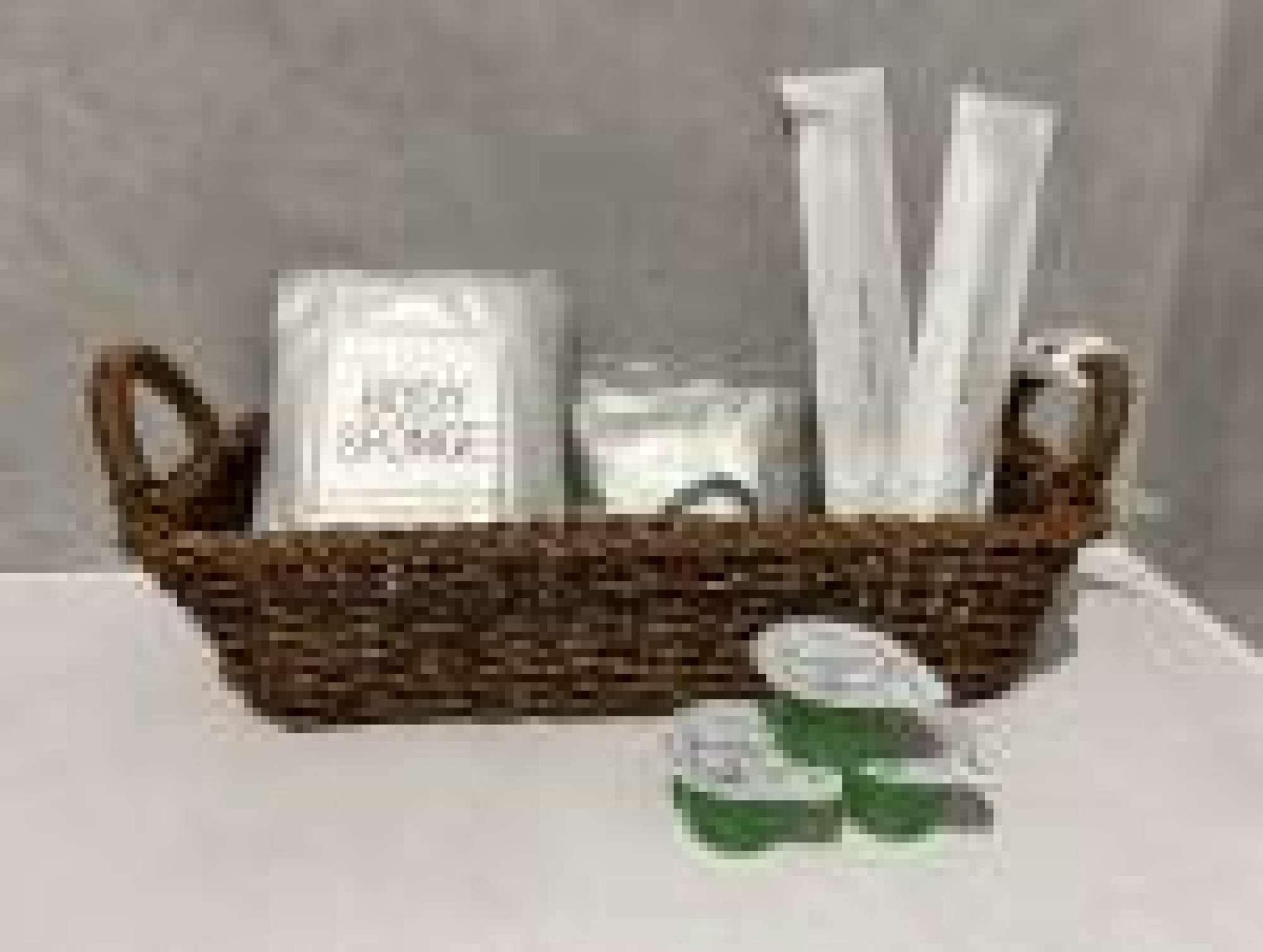 A wicker basket containing toiletries and a green item on a table.
